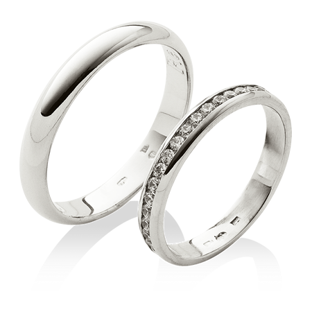 Platinové snubní prsteny s osázenými kameny v dámském prstenu