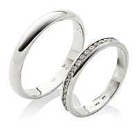 Platinové snubní prsteny s osázenými kameny v dámském prstenu